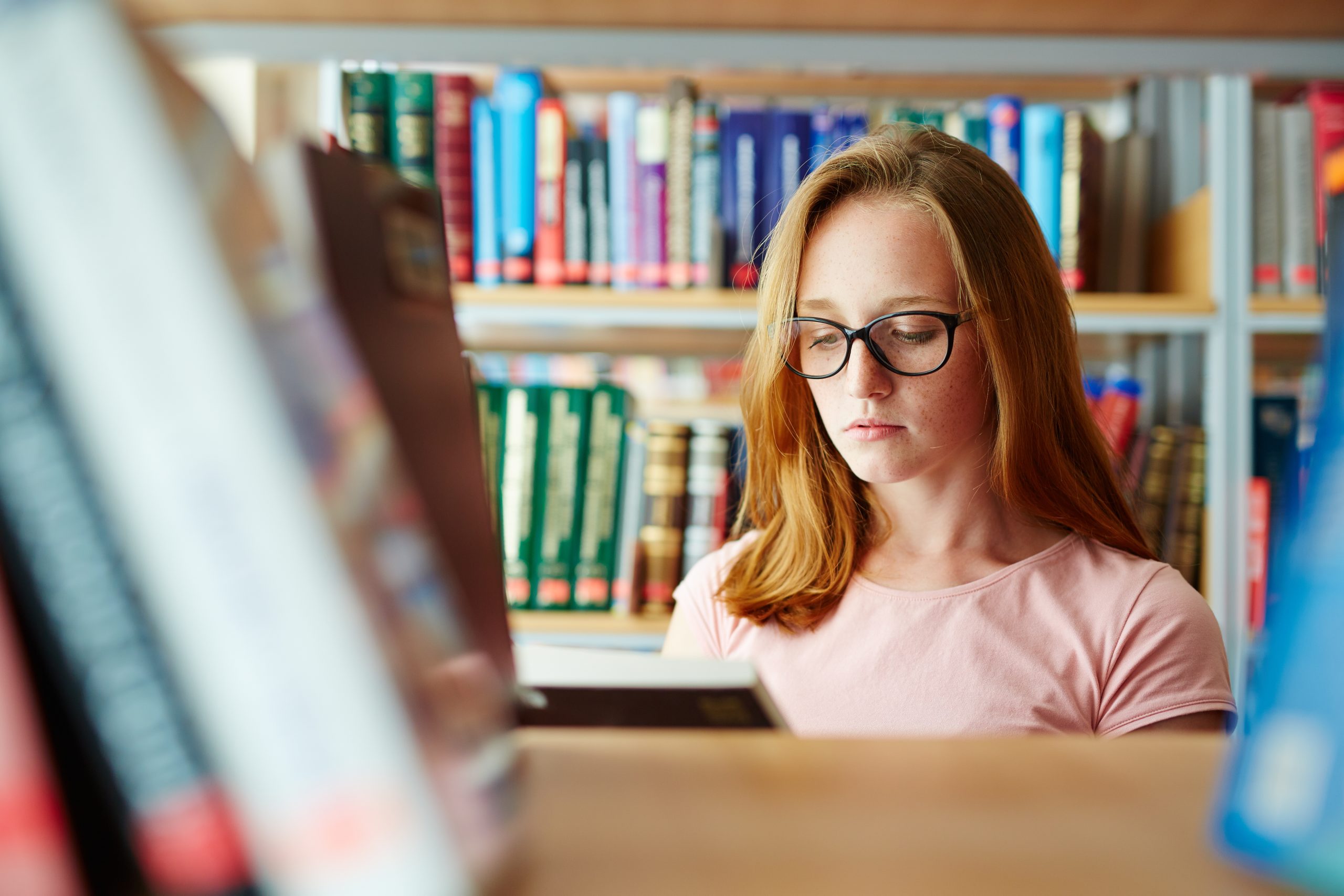 Teenage book-lover spending free time by reading